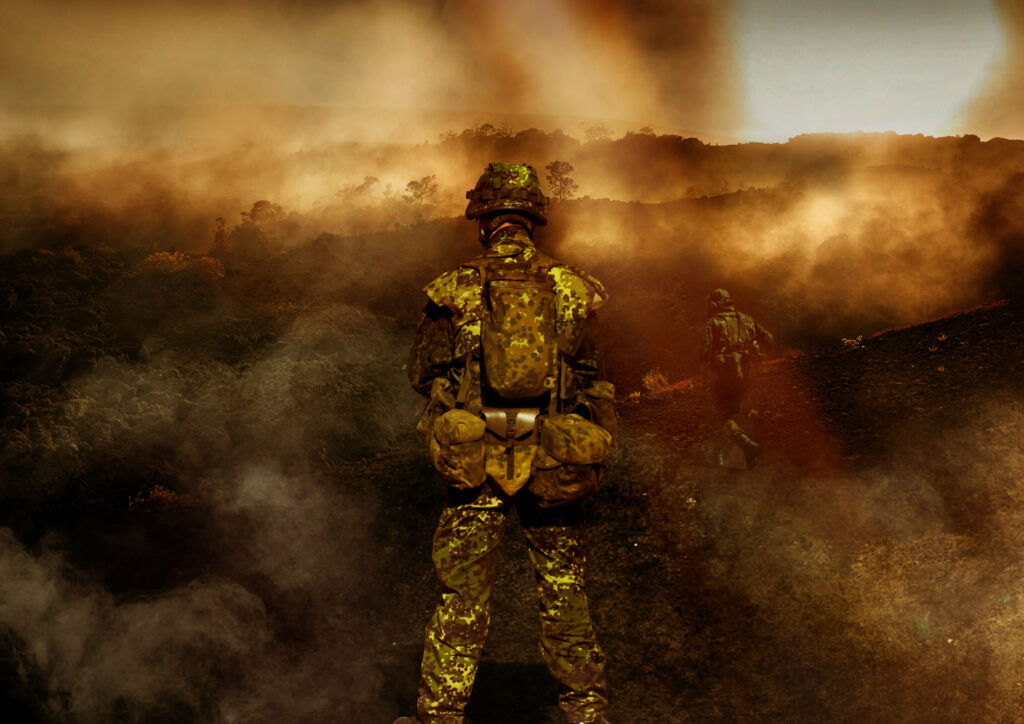 Soldiers moving through heavy smoke and haze on deployment, illustrating burn pit and toxic exposure covered by the VA PACT Act